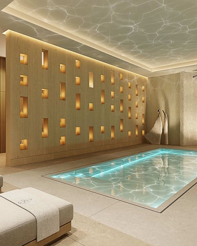 Luxury spa room with indoor pool, illuminated wood accent wall, lounge chairs, and ambient ceiling lighting